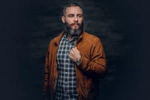 Bearded middle age male dressed new brown leather jacket