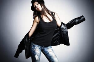young woman in leather jacket and hat shows lining