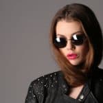 Lady in a studded leather jacket and circle sunglasses