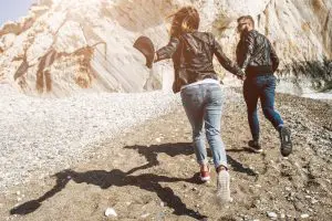 couple in the leather jackets running in summer