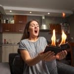 young woman holding leather wallet on fire