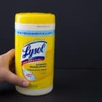 A person holding Lysol Disinfecting Wipes - Lemon and Lime