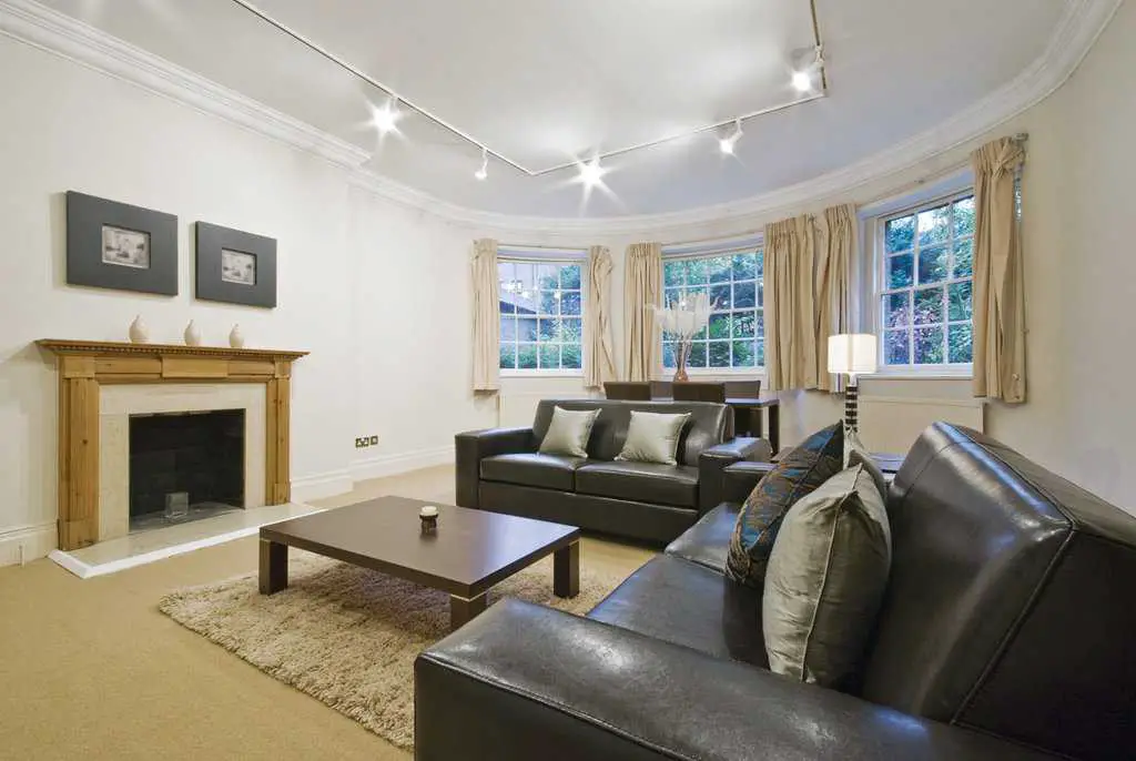 massive living room with bay window and luxury italian leather sofas