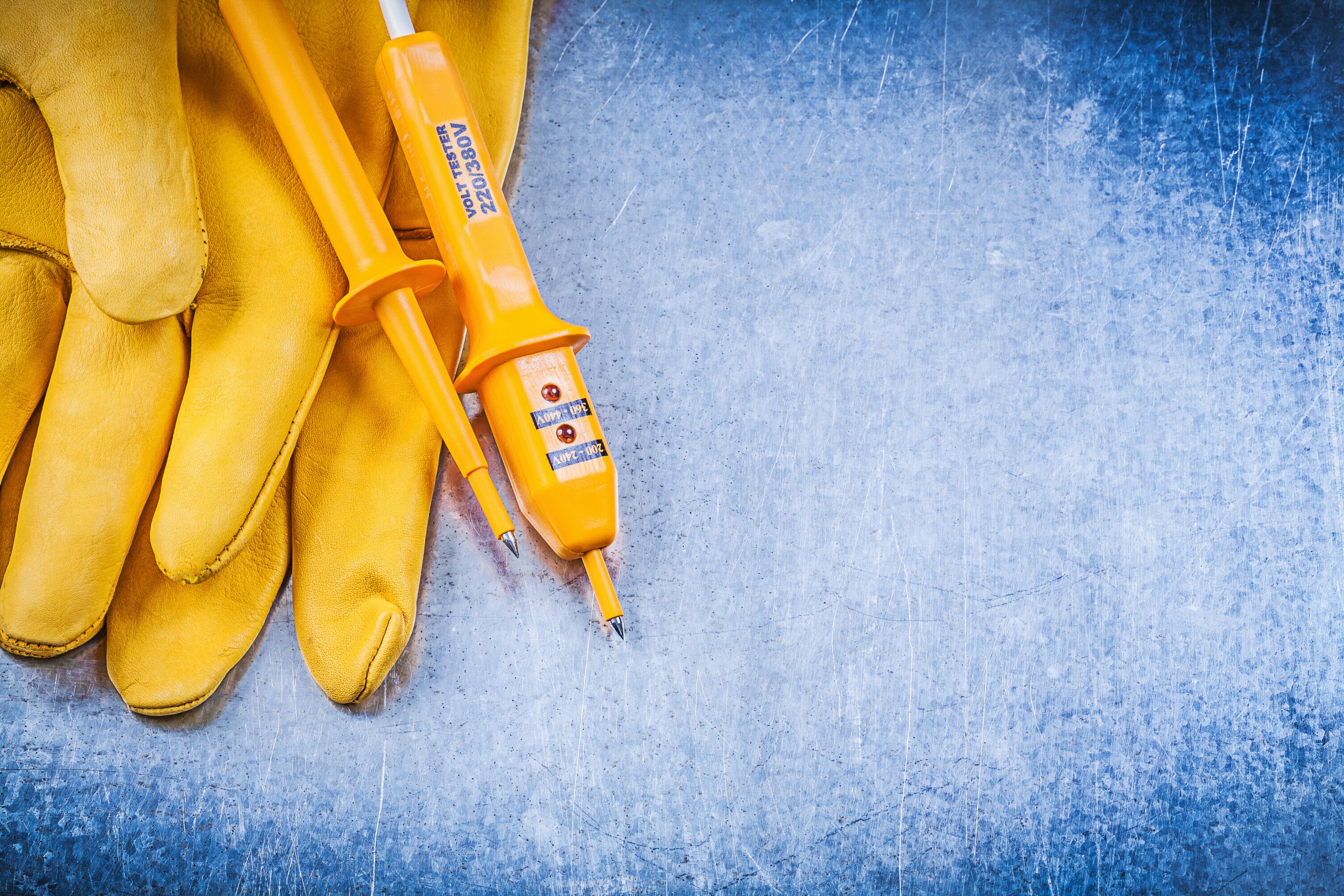 Yellow electrical tester and safety leather gloves