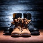 vintage father and son breathable leather boots on wooden surface