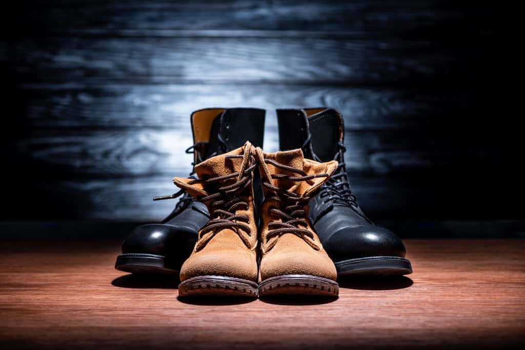 vintage father and son breathable leather boots on wooden surface